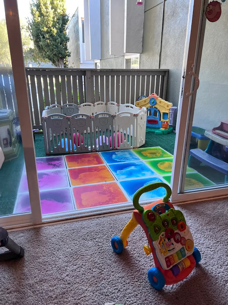 View from inside the daycare to the outdoor balcony play area with baby walker