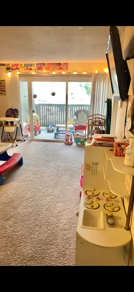 Play kitchen area and high chairs inside the daycare